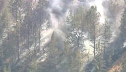 Smoke rises from Willow Creek Canyon after a small plane crash near the Madras, OR, airport left one person dead Sunday.