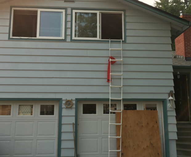 A collapsible ladder remains in place Tuesday after a boy used it to escape a Northwest Portland fire sparked by a hoverboard.