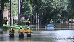 Members of Nebraska Task Force One (NE-TF1) comb a neighborhood for survivors impacted by flooding from Hurricane Harvey.