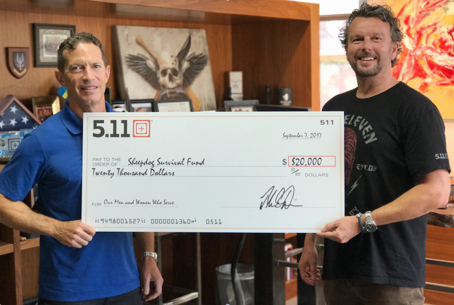 5.11 Tactical&rsquo;s CEO, Tom Davin, and VP of Global Marketing, Willem Driessen, holding a $20,000 check from 5.11 to the Sheepdog Survival Fund.
