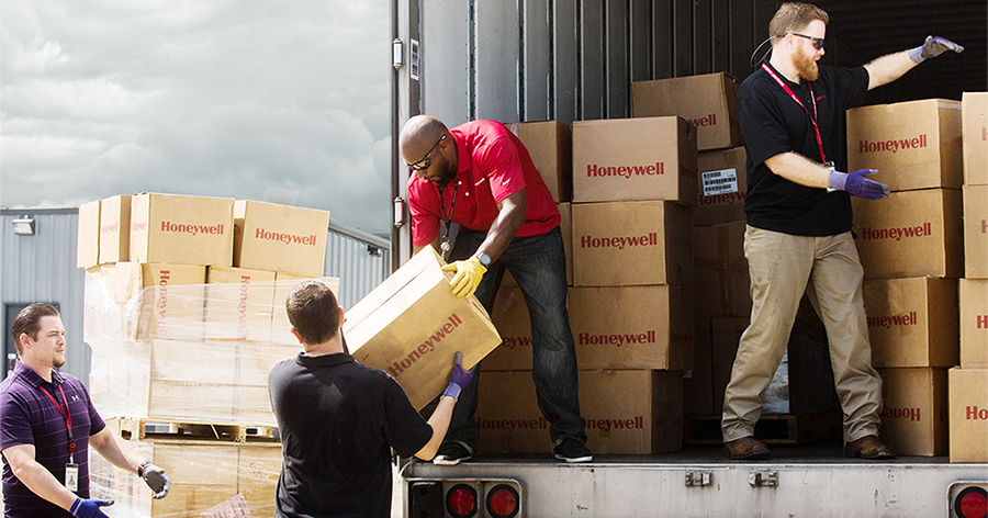 Honeywell employees unload safety equipment for immediate delivery to first responders and emergency personnel to support humanitarian relief efforts in Houston after Hurricane Harvey.