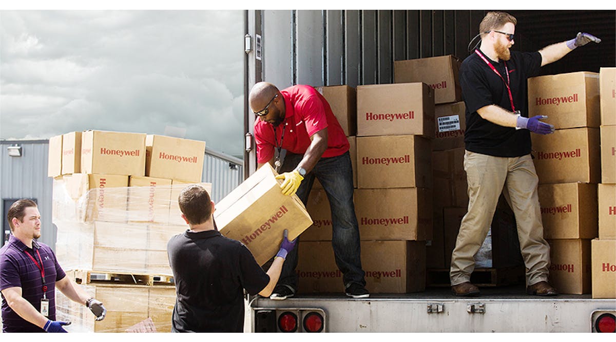 Honeywell employees unload safety equipment for immediate delivery to first responders and emergency personnel to support humanitarian relief efforts in Houston after Hurricane Harvey.
