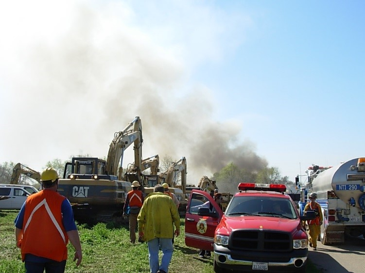 Heavy equipment and foam tenders staging for what is going to be long day on a railroad trestle fire and collapse.