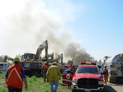 Heavy equipment and foam tenders staging for what is going to be long day on a railroad trestle fire and collapse. Heavy equipment and foam tenders staging for what is going to be long day on a railroad trestle fire and collapse.