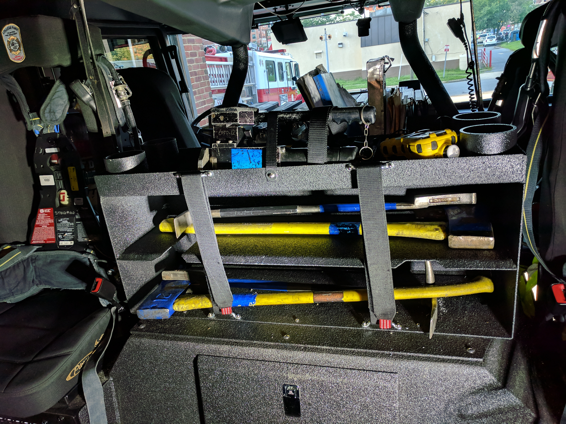 The rear crew area on College Park, MD, Truck 12 carries two sets of irons, a Hydra Ram and other equipment.