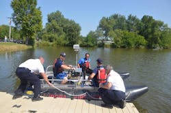Aurora, IL, firefighters prepare to conduct an exercise on the Fox River in August. Aurora, IL, firefighters prepare to conduct an exercise on the Fox River in August.
