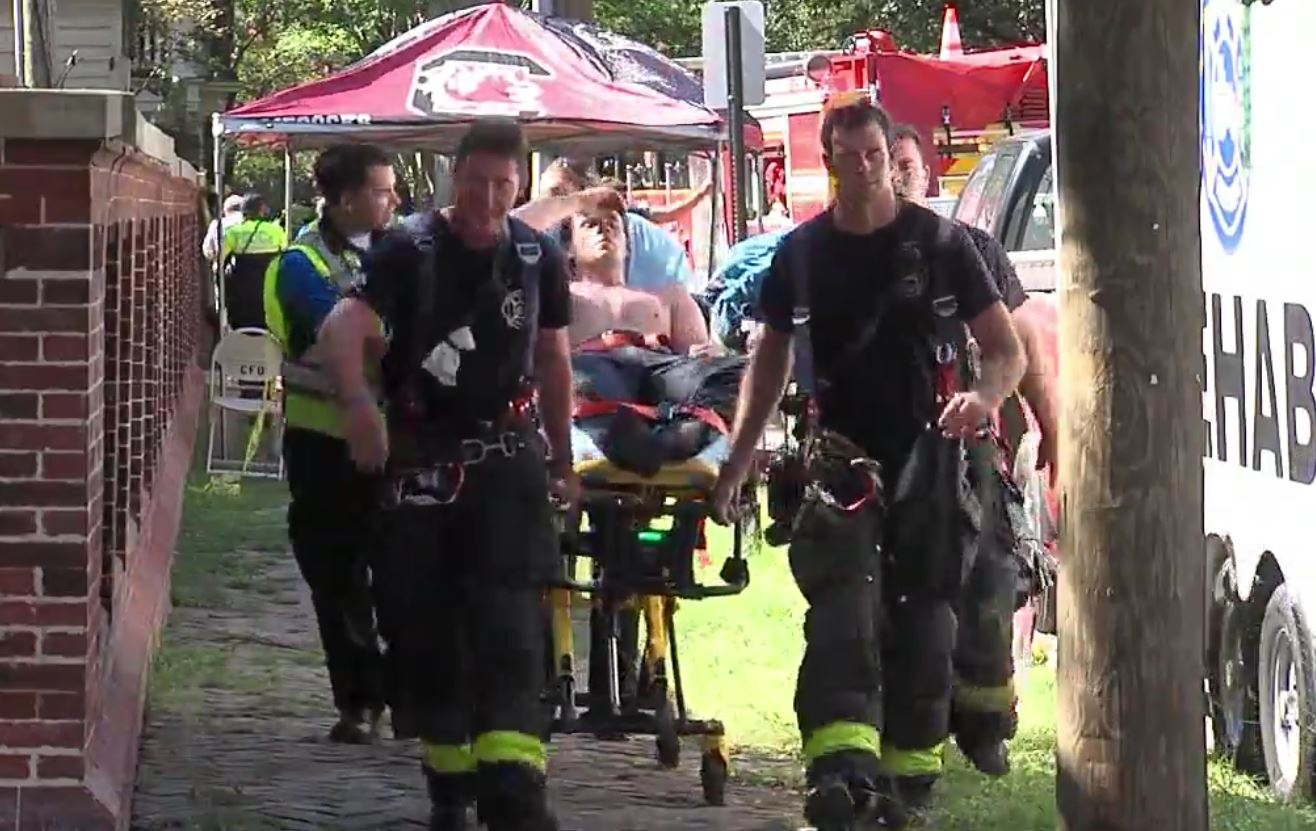Charleston, SC, firefighter Cameron Day is wheeled on a stretcher by his colleagues July 14 after heroically charging into a burning house to save a woman who broke through the fire line to find her cat.