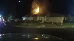 This image from a dashcam video shows firefighters setting up to tackle a house fire in Eagle Point, OR, on Monday.