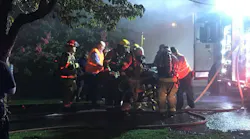 Chattanooga firefighters attend to a woman they pulled from a burning home Wednesday, which was one of four fires in Lookout Valley inside of a week.