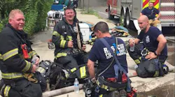 A group of Trenton firefighters cool down and hydrate during a call in July.