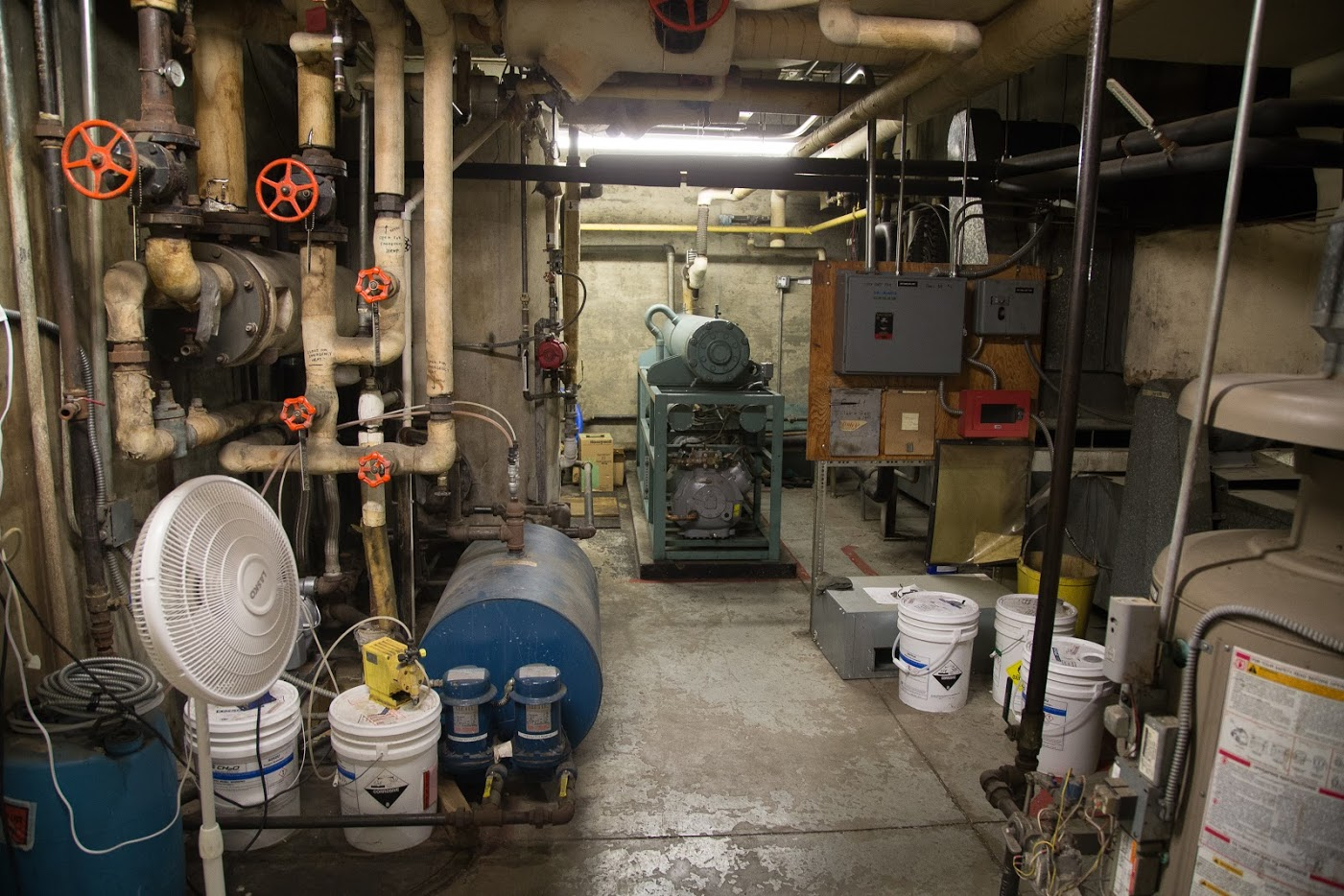 When the door to the mechanical room was opened, there was a light haze inside, and firefighters reported hearing a hissing noise that seemed to be coming from a green cylinder. Upon entering the room, the four firefighters began to feel lightheaded.