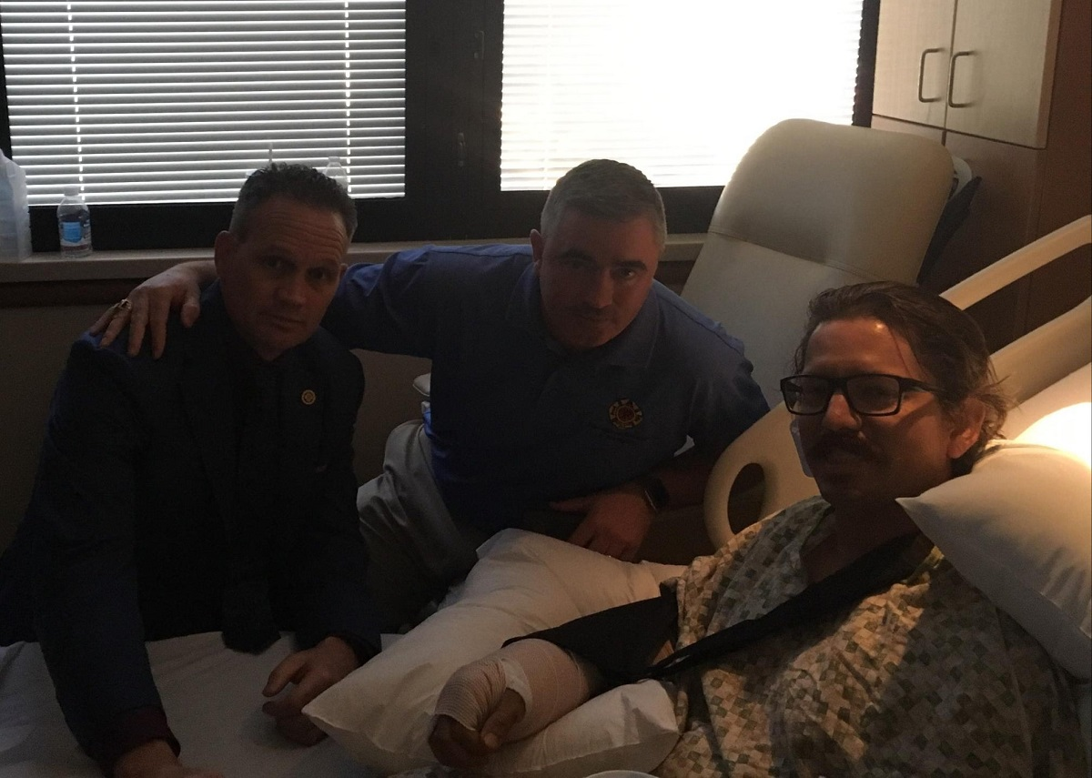 Los Angeles City firefighter Frank Lima, left, tweeted this photo after visiting an unidentified San Bernardino County firefighter who was shot in the arm in Las Vegas on Sunday night while rendering CPR.