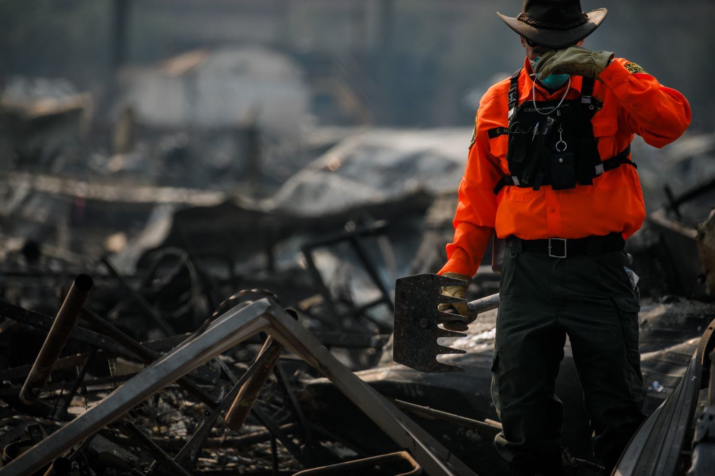 A search worker takes a quick respite as search teams canvas through the debris of mobile homes after the Journey's End Mobile Home Park in Santa Rosa, CA, was destroyed by wildfire, on Friday, Oct. 13, 2017.