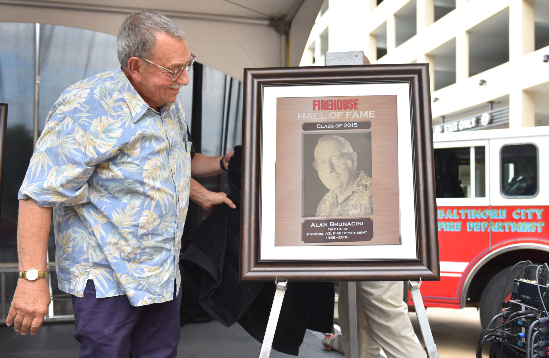 Alan Brunacini unveils his plaque during the Firehouse Hall of Fame induction ceremony at Firehouse Expo 2015.