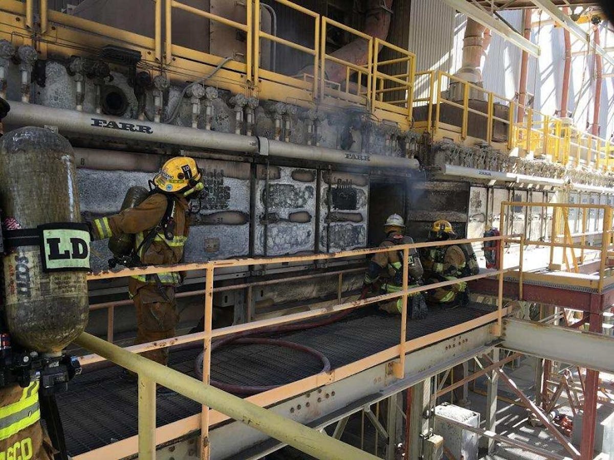 Firefighters work to contain a mechanical blaze that broke out in a secondary ore crusher at a mining facility in Green Valley, AZ, on Monday.
