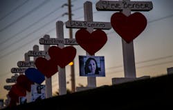Wooden crosses bearing the names of those killed during the Oct. 1 mass shooting in Las Vegas line the median near the &apos;Welcome to Las Vegas&apos; sign off Las Vegas Boulevard.
