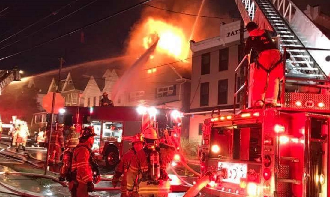 Wilkes-Barre, PA, firefighters at the scene of a house fire where two men were arrested for scuffling with fire crews and police, one facing aggravated assault charges.