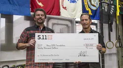 Vice President of Global Marketing, Willem Driessen and 5.11 CEO, Tom Davin, holding the $20,000 check for Navy SEAL Foundation.