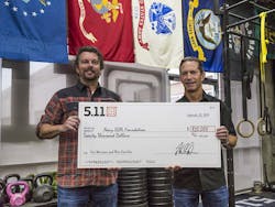 Vice President of Global Marketing, Willem Driessen and 5.11 CEO, Tom Davin, holding the $20,000 check for Navy SEAL Foundation.