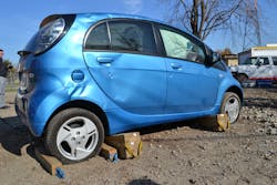 The Mitsubishi i-MiEV is one example of an EV with a floorpan-mounted lithium-ion battery. Stabilization of an EV such as this is best accomplished with chocks on both sides of a tire on the drive axle plus cribbing placed along the rocker on both sides of the vehicle. Photos by Ron Moore The Mitsubishi i-MiEV is one example of an EV with a floorpan-mounted lithium-ion battery. Stabilization of an EV such as this is best accomplished with chocks on both sides of a tire on the drive axle plus cribbing placed along the rocker on both sides of the vehicle. Photos by Ron Moore