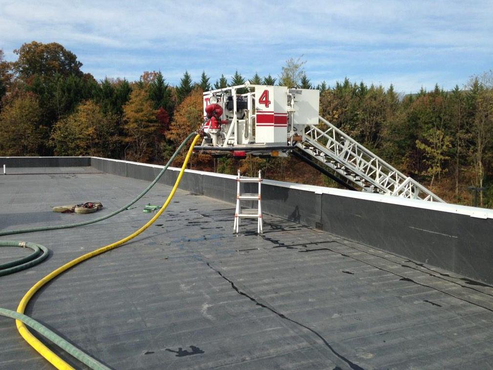 The flying standpipe being used to supply two handlines through the use of the discharge outlet located on the bucker of the aerial ladder.