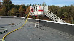 The flying standpipe being used to supply two handlines through the use of the discharge outlet located on the bucker of the aerial ladder.