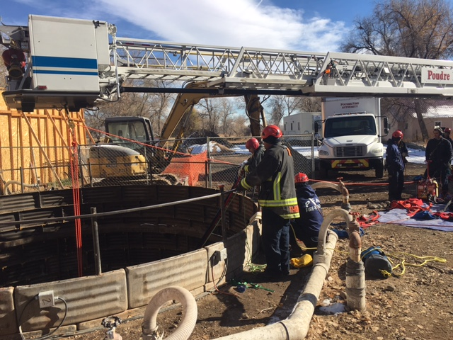 Photo 1: The bucket of Tower 1 was centered over the access point and used as the high anchor point for the 4:1 hauling system.