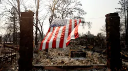 A U.S. flag hangs from the remnants of a fire-ravaged home on Willowview Court in the Coffee Park neighborhood of Santa Rosa, CA, on Oct. 18, 2017.