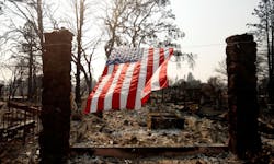 A U.S. flag hangs from the remnants of a fire-ravaged home on Willowview Court in the Coffee Park neighborhood of Santa Rosa, CA, on Oct. 18, 2017.