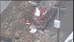 Debris can be seen atop a crushed St. Louis fire apparatus after a wall collapsed during a massive fire Wednesday at a warehouse containing over 150,000 citronella candles. Debris can be seen atop a crushed St. Louis fire apparatus after a wall collapsed during a massive fire Wednesday at a warehouse containing over 150,000 citronella candles.