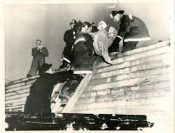 A vintage photo showing one of 18 victims being removed from the scene of the Moonglow Hotel fire in Niagara Falls, NY, in November 1957.