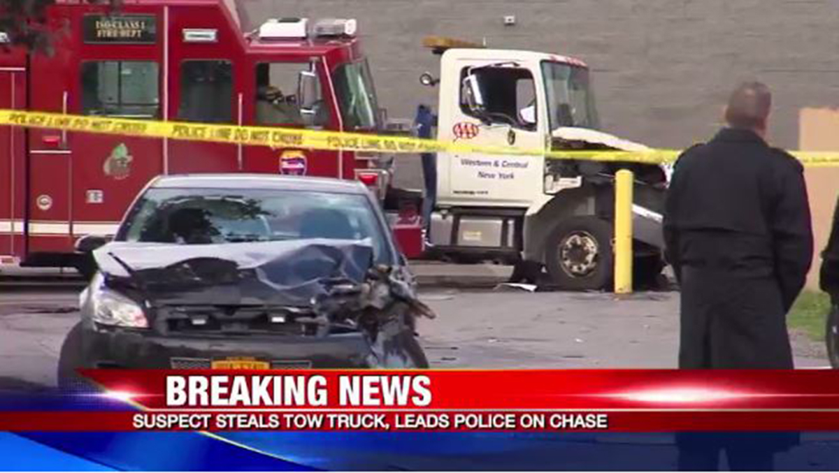 The flatbed damaged several police and fire vehicles in Syracuse.