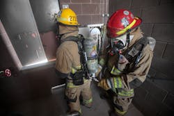 A firefighter refills an air bottle during a high-rise fire using Firefighter Air Replenishment System (FARS) quick fill. A firefighter refills an air bottle during a high-rise fire using Firefighter Air Replenishment System (FARS) quick fill.