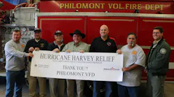 Officials from Philmont, Port Aransas and Texas A&M Forest Service pose for a photo with the donated pumper.