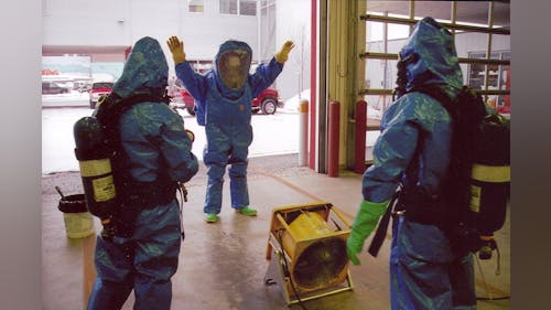 Men doing dry decontamination.