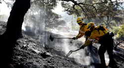Firefighters work to put out a brush fire in Malibu, CA, in the hills above Pt. Dume on Thursday, Dec. 7, 2017.
