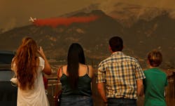 Onlookers watch as a tanker drops flame retardant material on hot spots in Carpenteria, CA, on Dec. 11, 2017, during efforts to contain the Thomas Fire. Onlookers watch as a tanker drops flame retardant material on hot spots in Carpenteria, CA, on Dec. 11, 2017, during efforts to contain the Thomas Fire.