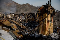 Heat and smoke rise from the rubble of a home destroyed by the Thomas Fire on Sunday, Dec. 17, 2017 in Montecito, CA.