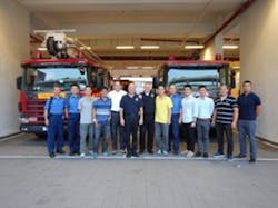 A group photo of instructors and students in front of the fire academy in Hong Kong. A group photo of instructors and students in front of the fire academy in Hong Kong.