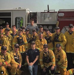 Actor Rob Lowe poses with firefighters battling the Thomas Fire in Ventura and Santa Barbara counties after thanking them with a home-cooked meal.
