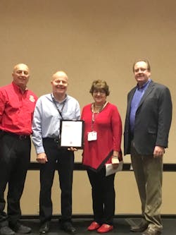 Corey D. Lane (second from left) received the 2017 EVT of the Year Award from FDSOA Executive Director Rich Marinucci (left to right), Firehouse Special Projects Director Janet Wilmoth and Spartan Motors National Sales Manager Brian Connely.