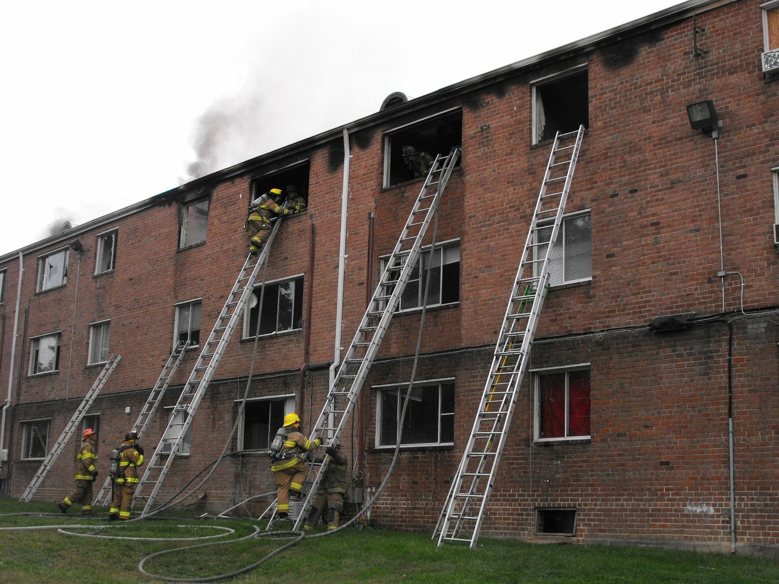 Crews did a good job with ground ladder placement at this fire in a three-story, ordinary construction apartment complex. First- and second-arriving ladder companies must carry a good assortment of straight, roof and extension ladders.