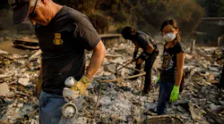 Jeff Lipscomb, from left, Gabriel Lipscomb, 17, and Rachel Lipscomb, 11, look for items to recover in the wreckage of their burned home on Dec. 6, 2017, in Ventura, CA.