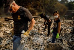 Jeff Lipscomb, from left, Gabriel Lipscomb, 17, and Rachel Lipscomb, 11, look for items to recover in the wreckage of their burned home on Dec. 6, 2017, in Ventura, CA. Jeff Lipscomb, from left, Gabriel Lipscomb, 17, and Rachel Lipscomb, 11, look for items to recover in the wreckage of their burned home on Dec. 6, 2017, in Ventura, CA.