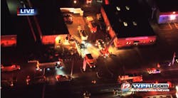 Emergency crews at the scene of a three-alarm fire in Cranston that resulted in 12 firefighters being hospitalized.