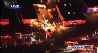 Emergency crews at the scene of a three-alarm fire in Cranston that resulted in 12 firefighters being hospitalized.