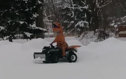Erie, PA, firefighter Steve Moore had a little fun on New Year&apos;s Day by plowing five feet of snow off his fire station&apos;s parking lot in a T-Rex costume.