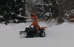 Erie, PA, firefighter Steve Moore had a little fun on New Year's Day by plowing five feet of snow off his fire station's parking lot in a T-Rex costume. Erie, PA, firefighter Steve Moore had a little fun on New Year's Day by plowing five feet of snow off his fire station's parking lot in a T-Rex costume.