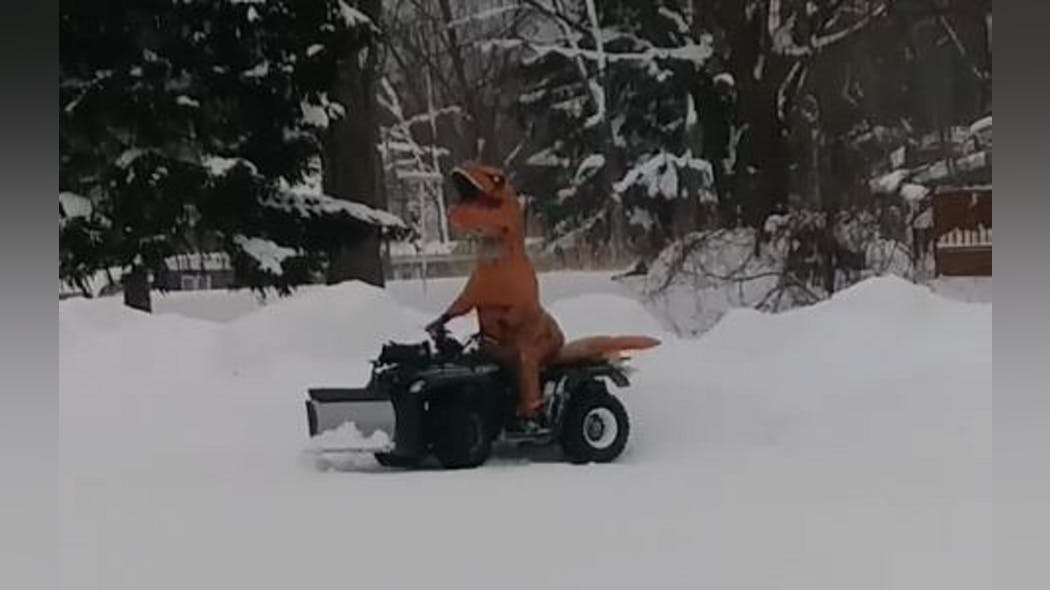 Erie, PA, firefighter Steve Moore had a little fun on New Year&apos;s Day by plowing five feet of snow off his fire station&apos;s parking lot in a T-Rex costume.