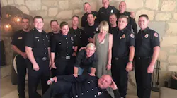TV host Ellen DeGeneres and her spouse Portia de Rossi pose with a group of firefighters who helped protect their Santa Barbara, CA, home from the Thomas Fire.